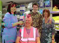 Scott styles hair into pink mohican for Autism Awareness Week