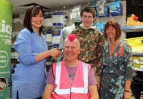 Scott styles hair into pink mohican for Autism Awareness Week
