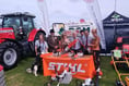 Kingsbridge Show chair and president try out chainsaws as they judge best trade stand