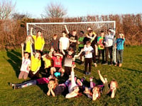 Village celebrates new goal posts with kids vs adults football game
