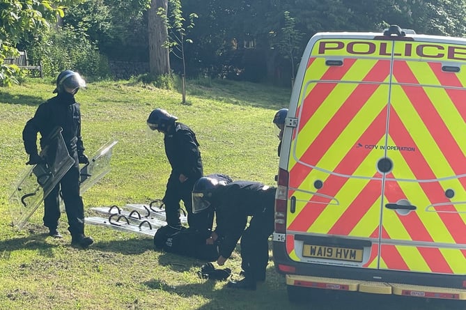 Officers dressing in riot gear to attend the incident in Crediton this morning, Wednesday, May 24.  AQ 9635