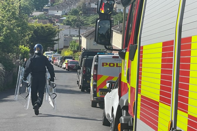 A police officer walking to the scene in Buller Road, Crediton, this morning, Wednesday, May 24.  AQ 9638