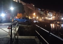 Woman falls from Brixham harbour wall