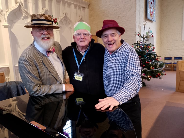 L to R: John Platt, Bryan Tucker Totnes Caring volunteer and local pianist Tom Unwin