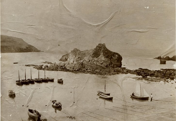 Boats moored at Hope Cove beach. Barney Bank Rock in centre with Bolt Tail on left of picture.  Circa 1900.  Before the Breakwater and sea wall were erected in 1924.