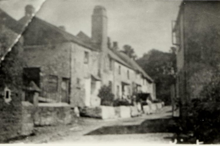 Kingston street scene of people leaning against wall. Circa 1930