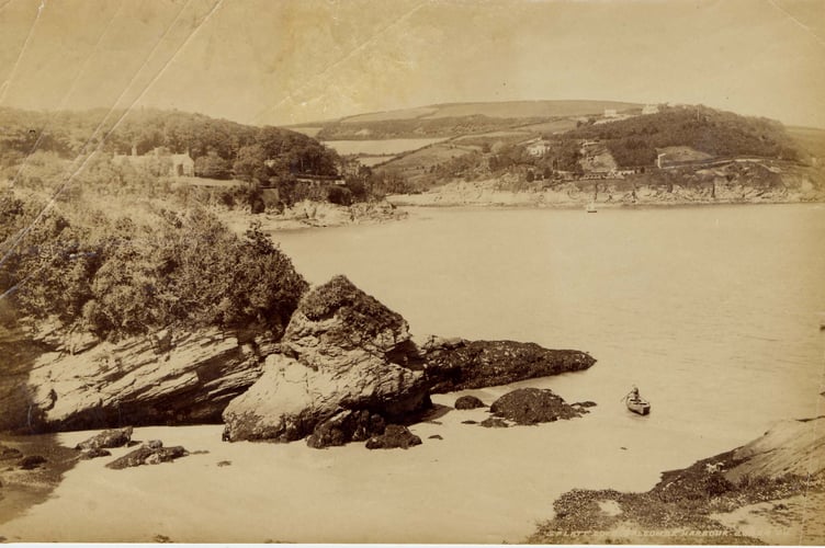 Splatt Cove, view northwards across South and North Sands towards Salcombe. Man in small boat near shore.