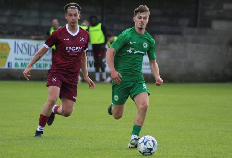 Ivybridge Town youngster Rio Daly with eyes on the ball against Paulton Rovers