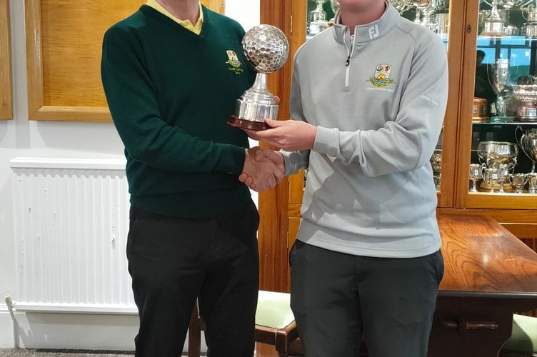 Club captain Jim Stewart presents Juniors captain George Inch with the Club v Juniors trophy