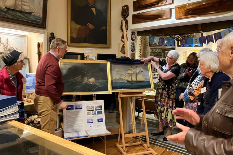 Bruce and Sheila Grant from Newfoundland unveiling their donated paintings of the Salcombe schooner Speedy at Salcombe Maritime Museum’s 50th birthday celebrations. Picture: SMM