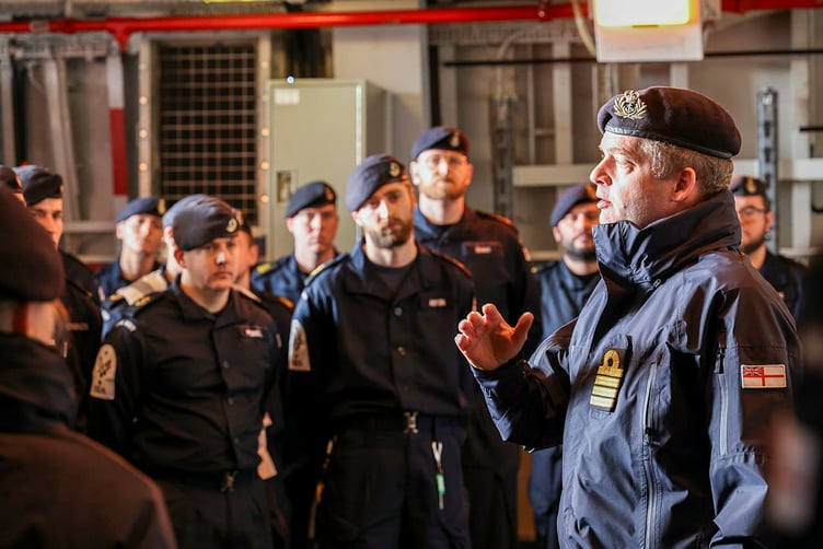 Commanding Officer, Commander James Wallington-Smith with members of the ship's company