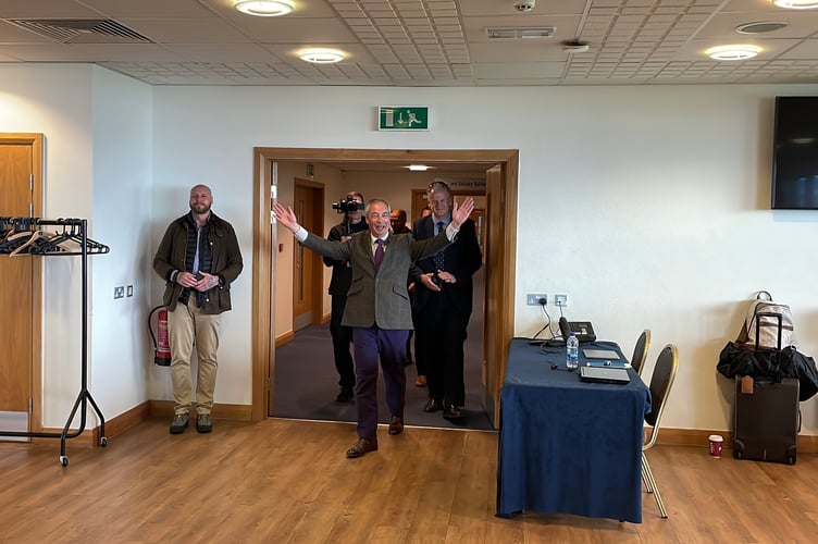 Mr Farage enters the conference room at Sandy Park to applause