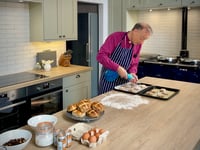 Bishop of Exeter prepares for Easter by baking hot cross buns
