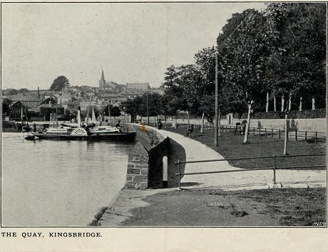 On east side of Kingsbridge estuary looking up to town. Paddle steamer in foreground