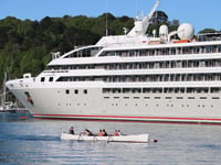 Rowers pass by 'Le Lyrial' cruise ship in the Dart 