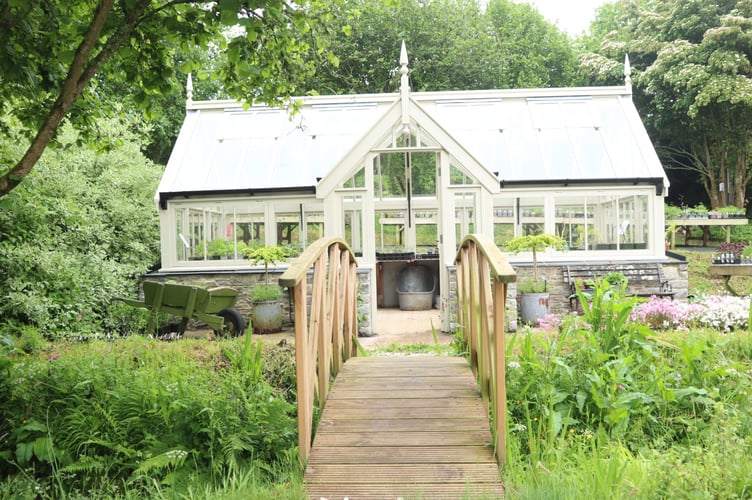 The bridge across the stream to the greenhouse