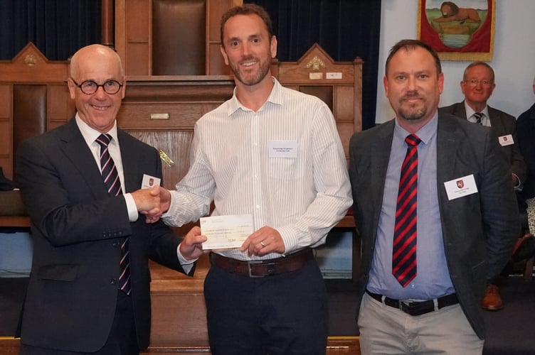 Chairman Dan Quiggin accepts a cheque for £1500. Courtesy of John Smerdon, Photographer for the Provincial Grand Lodge of Devonshire