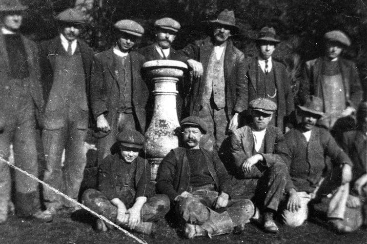 Workforce in garden at Combe Royal, Kingsbridge, Standing around an urn. Circa 1900