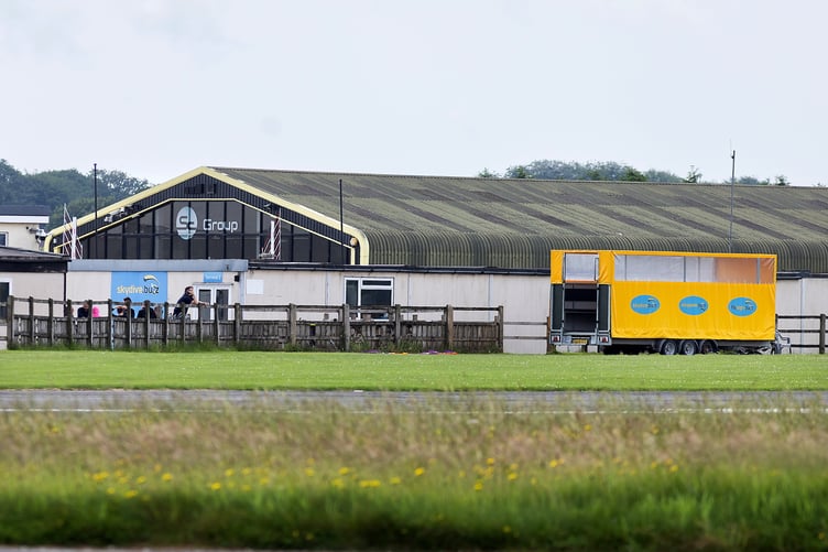 General view of Dunkeswell Airfield including Skydive Buzz, where two skydivers died after a tragic accident, involving a tandem jump on Friday June 13th. . Photo released June 14 2025. In a statement issued to British Skydiving members, Chief executive Robert Gibson wrote: "Today, Friday 13 June 2025, British Skydiving has been notified of a tragic accident in which two jumpers lost their lives. Our deepest condolences go to their families, friends and the entire skydiving community. "A British Skydiving Board of Inquiry will investigate the accident. Once complete, a report - setting out the Board's conclusions and any recommendations - will be submitted to the coroner, the police, the CAA, the British Skydiving Safety & Training Committee (STC) and any other relevant authorities.