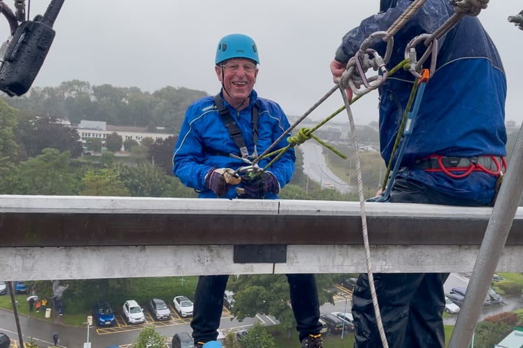 Abysmal weather did little to deter more than 120 thrill seekers who abseiled off Derriford Hospital building for charity.