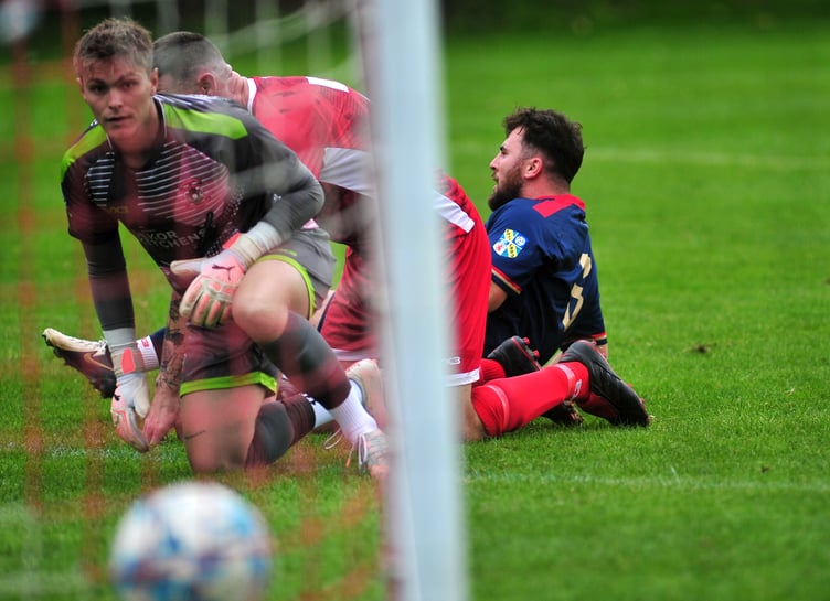 South Devon Football League Premier Division. Kingsteignton Athletic versus East Allington United. A single goal from the South Hams visitors saw the Rams take a 0-1 home loss. East Allington's Finley Bullen is on the deck but his shot has passed the Kingsteigton 'keeper to end up back of the net