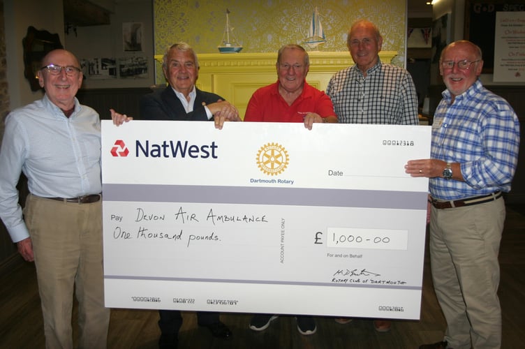 Dartmouth Rotary Club President Peter Goldstraw is pictured presenting the cheque to Rex Brown (centre) on behalf of the Devon Air Ambulance. Far left is club treasurer Bill Parker and (right) past president Bernard Young and Rotary fete and duck race organiser Keith Barker.