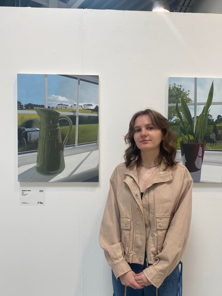 Madison Allen in front of winning paintings Distant and Firewood