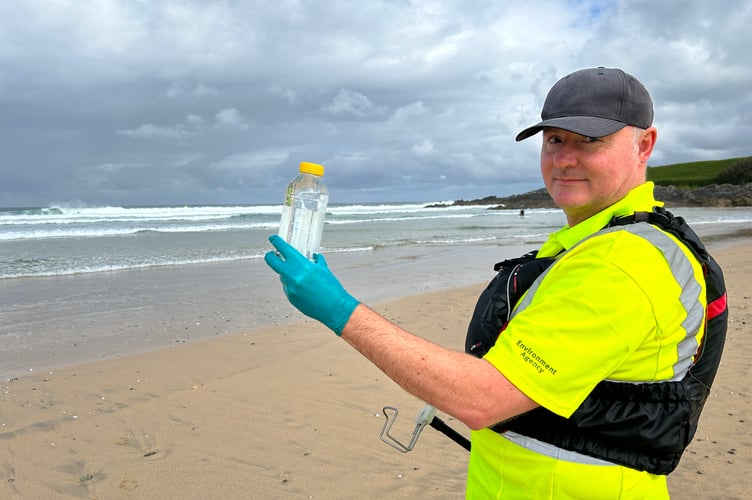 An Environment Agency officer taking a bathing water sample earlier this year