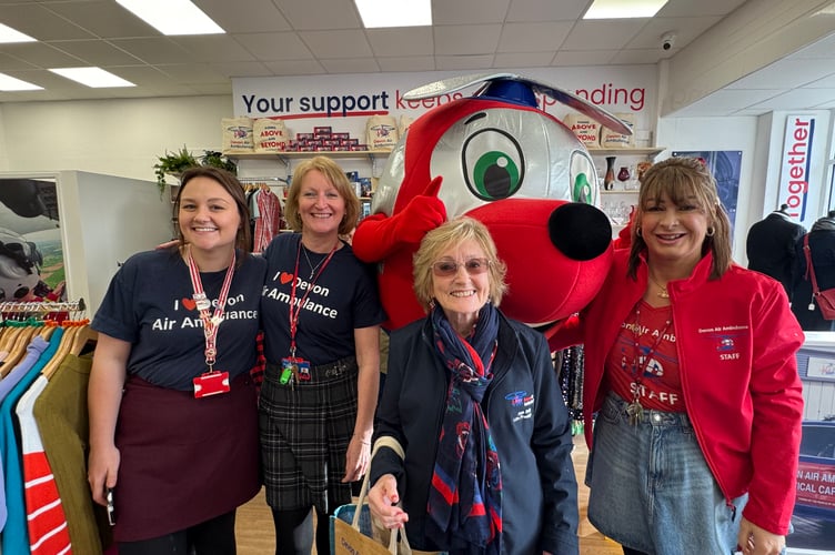 Ann Ralli, centre, with some of the Devon Air Ambulance staff and mascot Jennie.  AQ 0064
