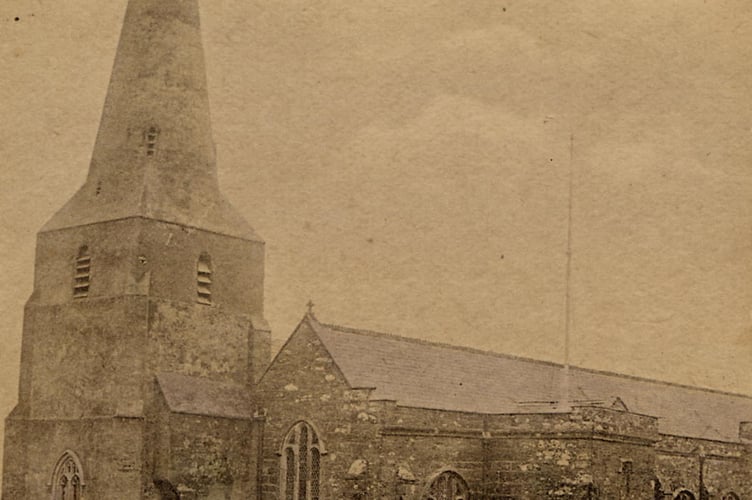 Pre-1921. All Saints Church and graveyard at Malborough with a man by a graveside