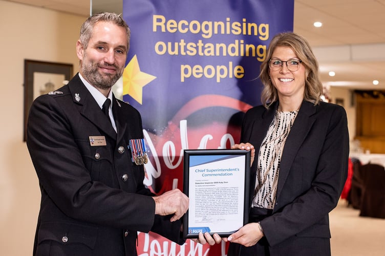 Head of Crime Det Chief Supt Ben Deer presenting a commendation to his wife, Detective Inspector Katy Deer