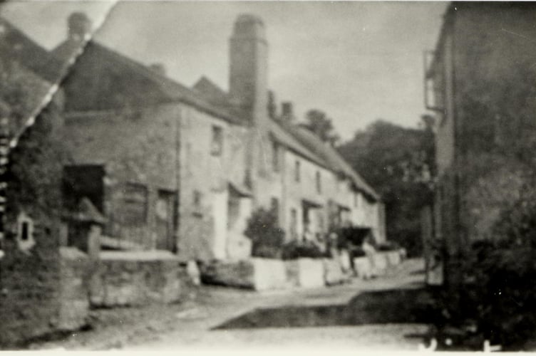 Rather blurred Kingston street scene of people leaning against wall around 1930