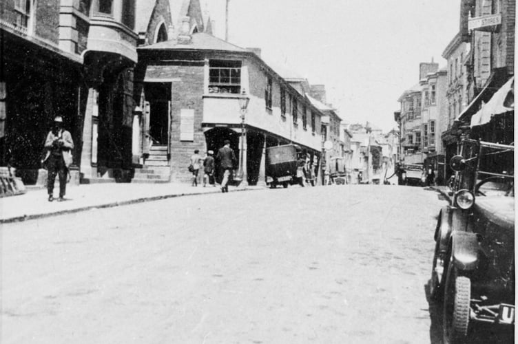 1920-1930 Shambles and Town Hall in Fore Street, Kingsbridge, with cars of the period in street.