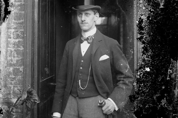 Young man in top hat outside door