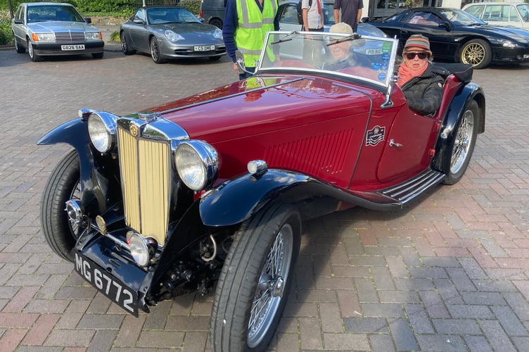 Making an entrance in a beautiful black and red MG