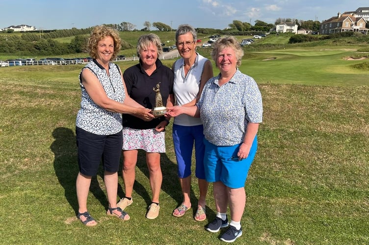 The Joan Mackenzie Trophy is presented to Heather Spencer, Pam  Adams and Sarah Loader by vice captain Sue Esplin.