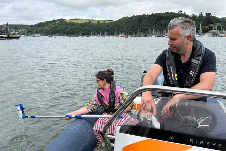Davina Luther from Friends of the Dart is pictured testing the water with Harbour Master Paul Britton