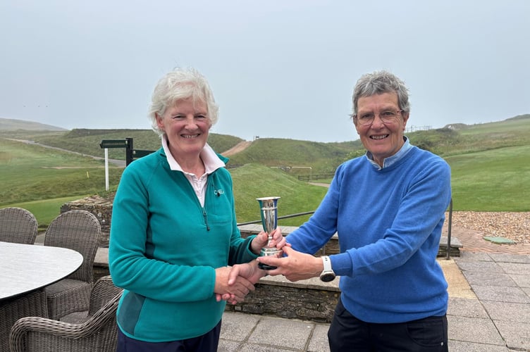 Helen Baker receives the Jennifer Yeo trophy from lady captain Heather Spencer