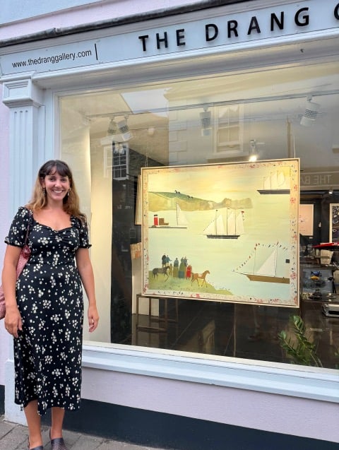 Holly Razavi outside The Drang with her painting 'Salcombe Schooners'.