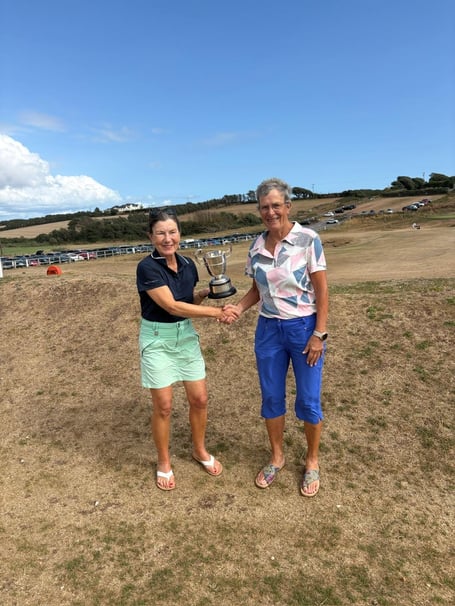 Zoe Lepere is presented with the Allcomers Cup by captain Heather Spencer